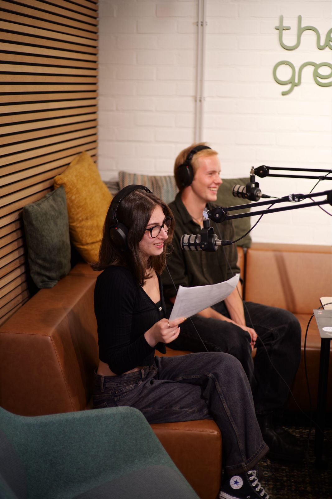 Students using podcast equipment.
